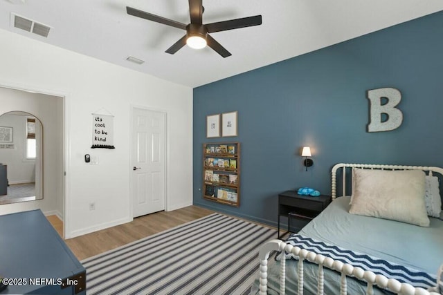 311 Wild Rose Dr, Saint Johns, FL 32259 - bedroom with arched walkways, visible vents, ceiling fan, and wood finished floors