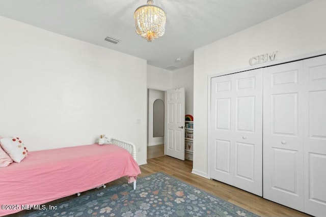 311 Wild Rose Dr, Saint Johns, FL 32259 - unfurnished bedroom featuring a chandelier, wood finished floors, a closet, and visible vents