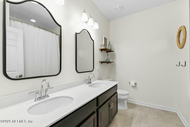 311 Wild Rose Dr, Saint Johns, FL 32259 - bathroom featuring double vanity, baseboards, a sink, and toilet