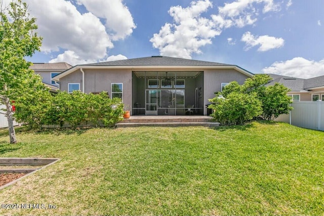 311 Wild Rose Dr, Saint Johns, FL 32259 - rear view of property featuring a yard, a sunroom, stucco siding, and fence