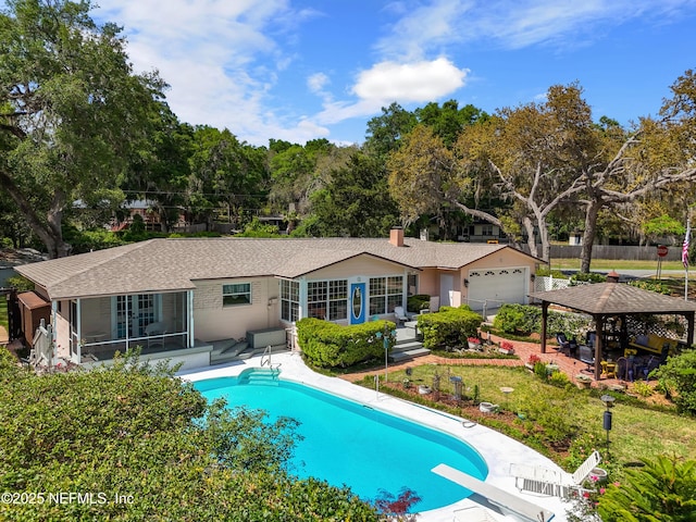 50 SE Forest St, Keystone Heights, FL 32656 - pool featuring a yard, fence, a sunroom, and a diving board
