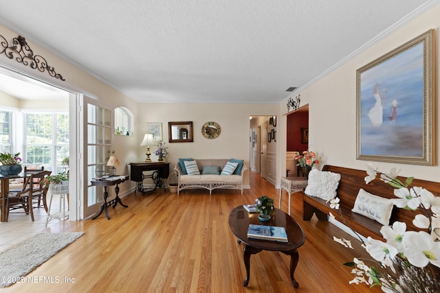 50 SE Forest St, Keystone Heights, FL 32656 - living room featuring light wood-style flooring, a textured ceiling, and crown molding
