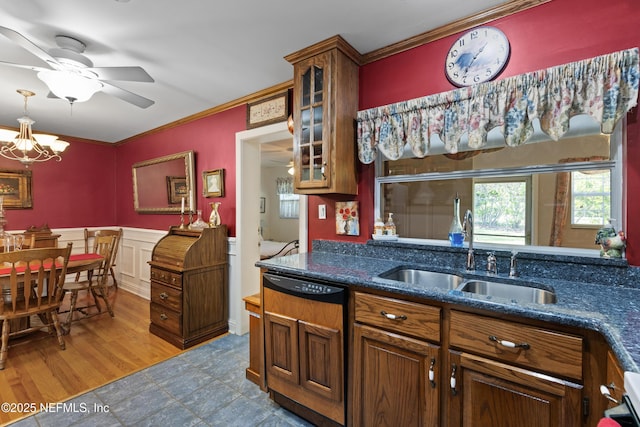 50 SE Forest St, Keystone Heights, FL 32656 - kitchen featuring dark stone countertops, glass insert cabinets, crown molding, ceiling fan with notable chandelier, and a sink