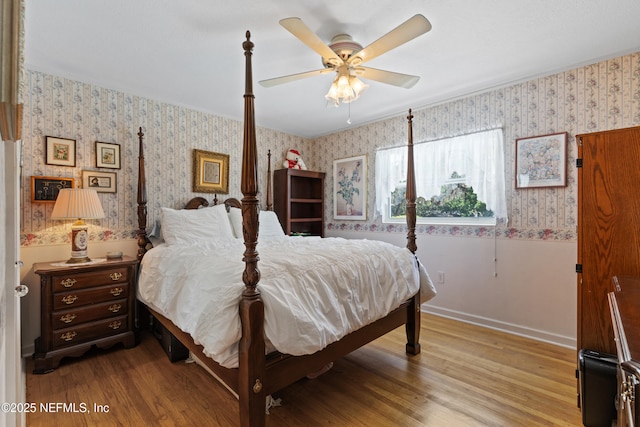 50 SE Forest St, Keystone Heights, FL 32656 - bedroom featuring a ceiling fan, wood finished floors, and wallpapered walls