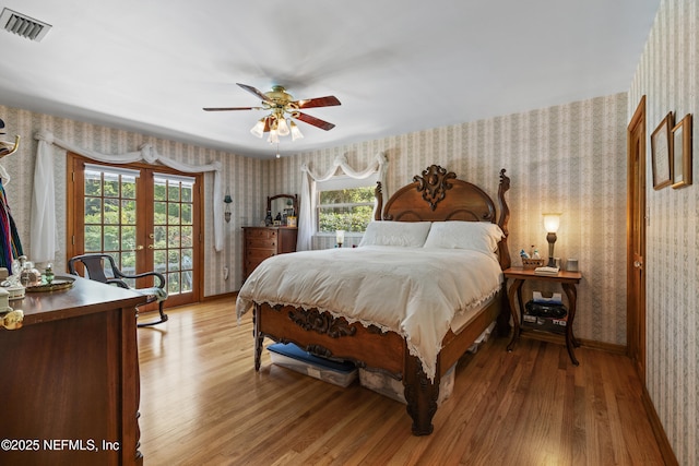 50 SE Forest St, Keystone Heights, FL 32656 - bedroom with french doors, wallpapered walls, and visible vents