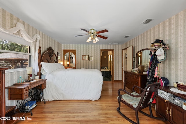 50 SE Forest St, Keystone Heights, FL 32656 - bedroom with light wood-type flooring, wallpapered walls, and visible vents