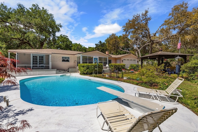 50 SE Forest St, Keystone Heights, FL 32656 - outdoor pool featuring a patio area, french doors, a gazebo, and a diving board