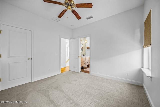 900 White St, Fernandina Beach, FL 32034 - unfurnished bedroom with carpet, baseboards, ensuite bath, and a ceiling fan