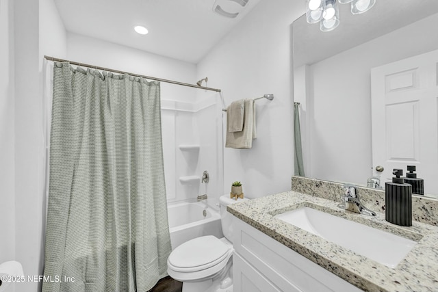 full bathroom with toilet, shower / bath combo with shower curtain, and vanity