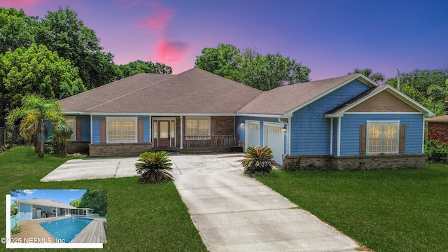 ranch-style home featuring a garage, brick siding, and a lawn