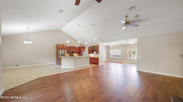 unfurnished living room featuring visible vents, ceiling fan, high vaulted ceiling, and light wood-style floors