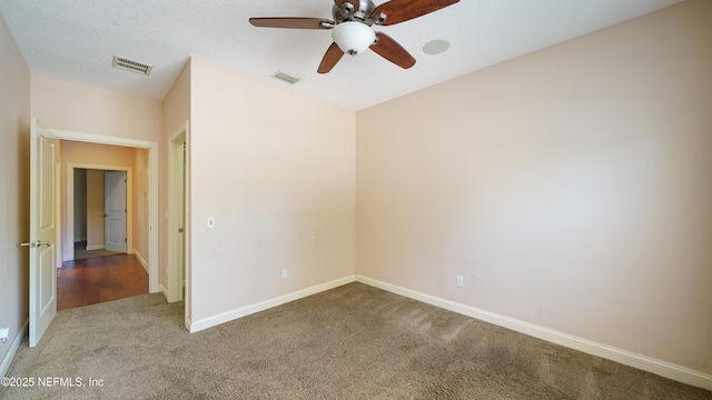 unfurnished room featuring visible vents, ceiling fan, carpet, and baseboards