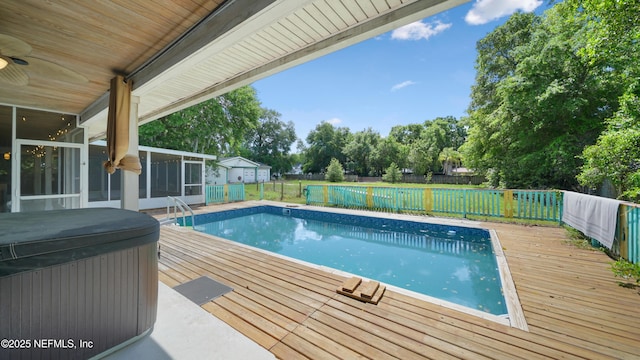 view of pool featuring a deck, a sunroom, a hot tub, a fenced backyard, and a fenced in pool