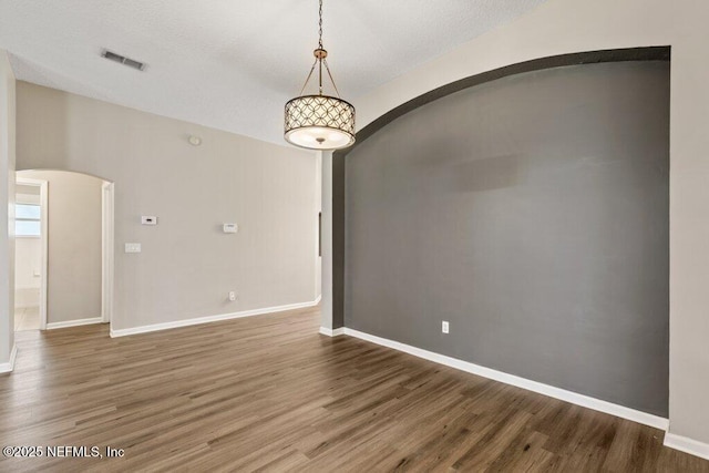 1029 Buttercup Dr, Saint Johns, FL 32259 - unfurnished room with arched walkways, wood finished floors, and baseboards