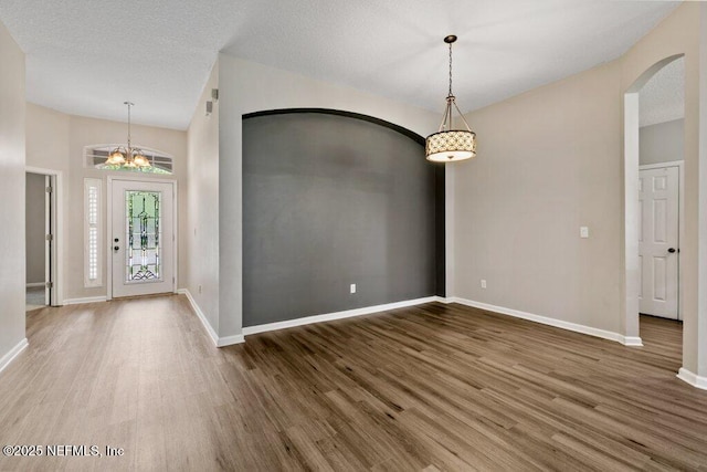 1029 Buttercup Dr, Saint Johns, FL 32259 - foyer entrance with arched walkways, wood finished floors, baseboards, and a chandelier