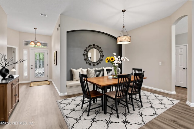 1029 Buttercup Dr, Saint Johns, FL 32259 - dining area featuring arched walkways, light wood-type flooring, and baseboards