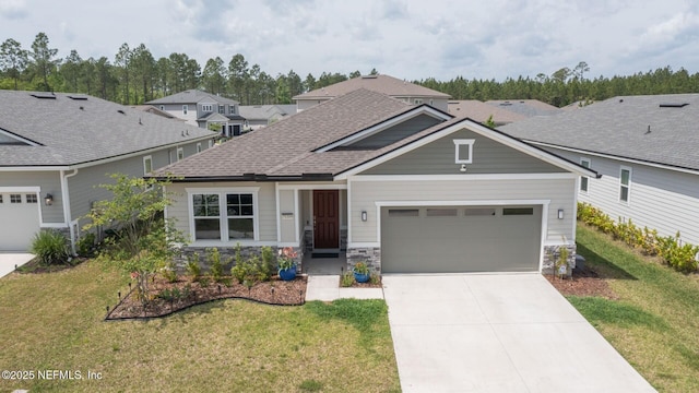 craftsman house featuring stone siding, a garage, concrete driveway, a front lawn, and roof with shingles