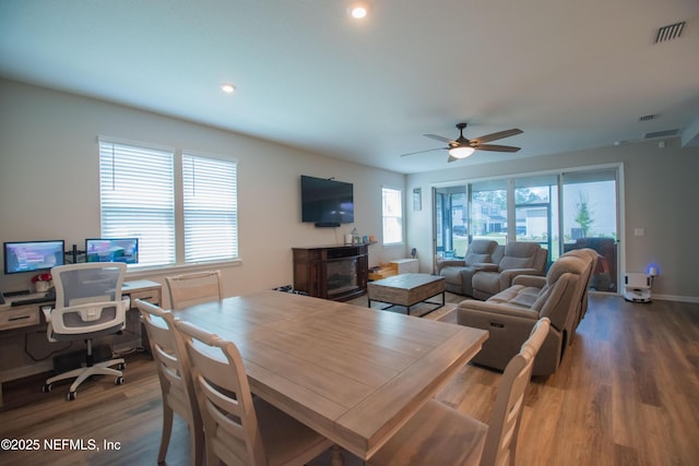 dining room with visible vents, baseboards, a ceiling fan, and wood finished floors