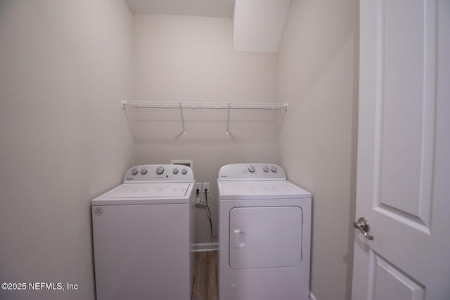 laundry room featuring laundry area, wood finished floors, and washer and clothes dryer