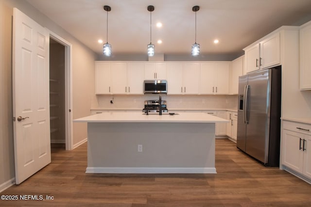 75309 White Rabbit Ave, Yulee, FL 32097 - kitchen featuring appliances with stainless steel finishes, dark wood-style flooring, backsplash, white cabinets, and recessed lighting