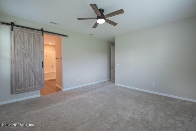 75309 White Rabbit Ave, Yulee, FL 32097 - carpeted empty room with a barn door and a ceiling fan