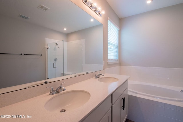 75309 White Rabbit Ave, Yulee, FL 32097 - full bathroom featuring a garden tub, a stall shower, double vanity, and recessed lighting
