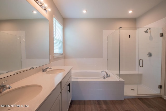 75309 White Rabbit Ave, Yulee, FL 32097 - full bathroom featuring a garden tub, wood finished floors, a shower stall, double vanity, and recessed lighting