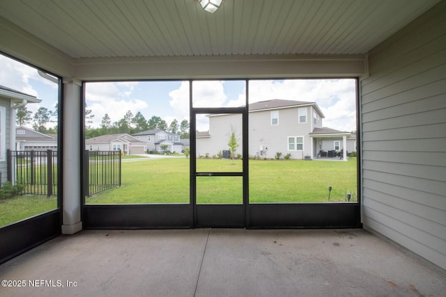 75309 White Rabbit Ave, Yulee, FL 32097 - unfurnished sunroom featuring plenty of natural light and a residential view