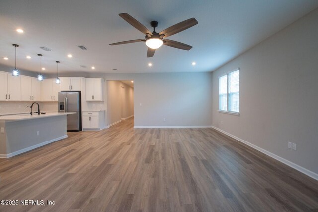 75309 White Rabbit Ave, Yulee, FL 32097 - unfurnished living room with recessed lighting, a ceiling fan, and wood finished floors