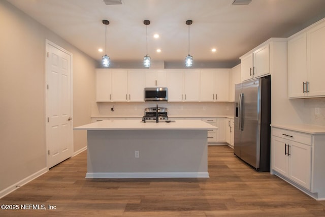 75309 White Rabbit Ave, Yulee, FL 32097 - kitchen with appliances with stainless steel finishes, backsplash, light countertops, white cabinetry, and recessed lighting