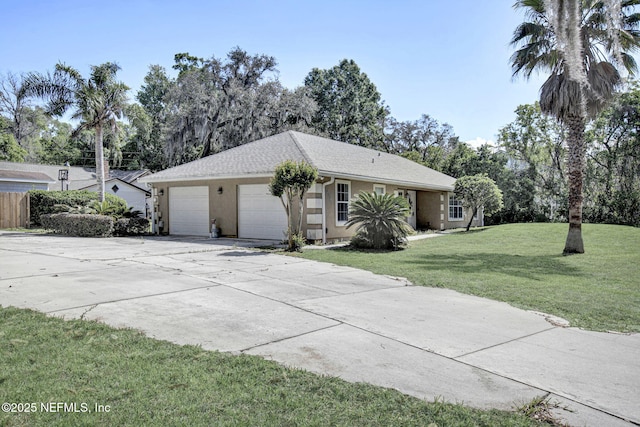 view of front of property with a garage, driveway, stucco siding, and a front lawn