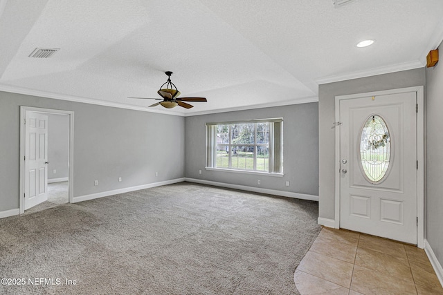 entryway with ceiling fan, ornamental molding, visible vents, carpet flooring, and baseboards
