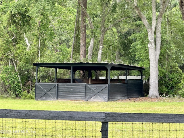 view of home's community featuring an outbuilding and a lawn