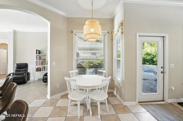 13738 Harbor Creek Pl, Jacksonville, FL 32224 - dining room with crown molding, light tile patterned floors, baseboards, and arched walkways