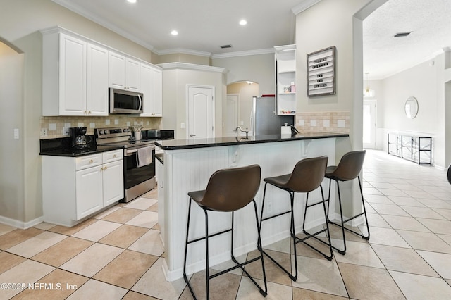 13738 Harbor Creek Pl, Jacksonville, FL 32224 - kitchen with ornamental molding, light tile patterned floors, a breakfast bar, and stainless steel appliances