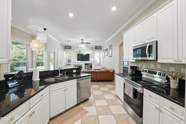 13738 Harbor Creek Pl, Jacksonville, FL 32224 - kitchen featuring tasteful backsplash, arched walkways, a sink, appliances with stainless steel finishes, and white cabinetry