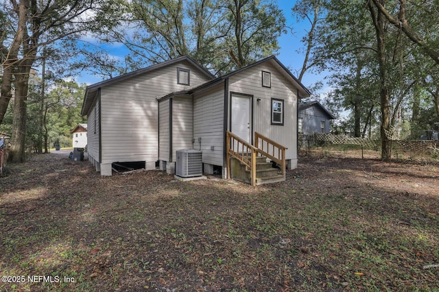 1354 Crestwood St, Jacksonville, FL 32208 - back of property featuring central AC unit, entry steps, and fence