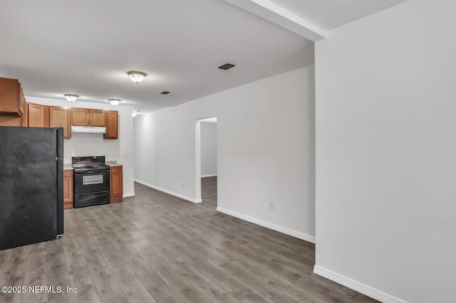 1354 Crestwood St, Jacksonville, FL 32208 - kitchen featuring visible vents, baseboards, light wood-style floors, under cabinet range hood, and black appliances