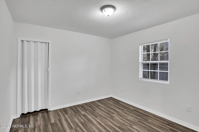 1354 Crestwood St, Jacksonville, FL 32208 - spare room with a textured ceiling, baseboards, and dark wood-style floors
