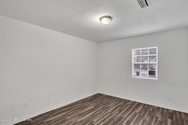 1354 Crestwood St, Jacksonville, FL 32208 - unfurnished room with dark wood-type flooring, visible vents, baseboards, and a textured ceiling