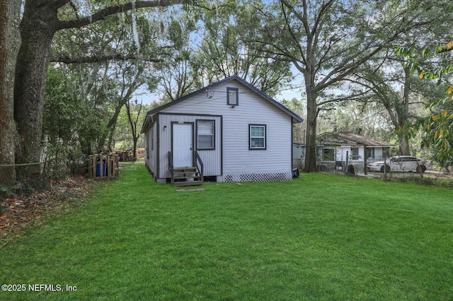 1354 Crestwood St, Jacksonville, FL 32208 - rear view of property with entry steps, fence, and a lawn
