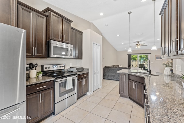 116 Timberwood Dr, Saint Augustine, FL 32084 - kitchen with appliances with stainless steel finishes, a sink, vaulted ceiling, open floor plan, and dark brown cabinetry