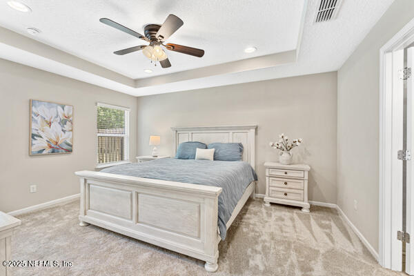 116 Timberwood Dr, Saint Augustine, FL 32084 - bedroom with light carpet, a tray ceiling, baseboards, recessed lighting, and a ceiling fan