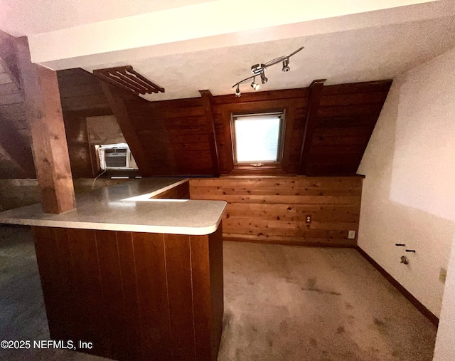 510 W Hillsborough Ave, Florahome, FL 32140 - kitchen with rail lighting, cooling unit, carpet flooring, wooden walls, and baseboards