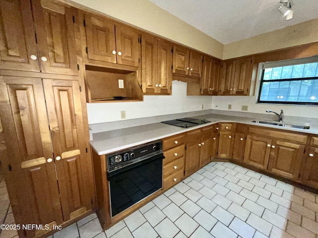510 W Hillsborough Ave, Florahome, FL 32140 - kitchen featuring brown cabinetry, light countertops, a sink, and black appliances