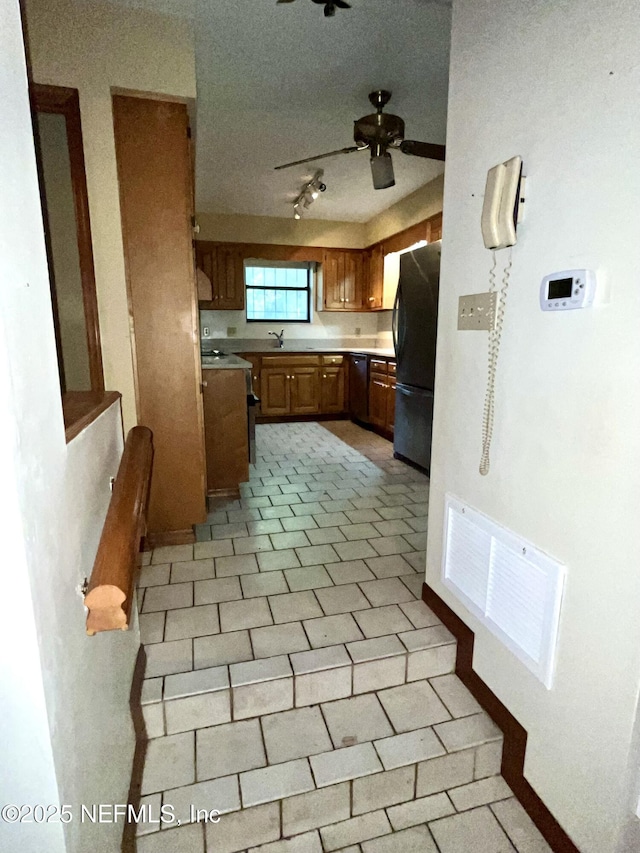 510 W Hillsborough Ave, Florahome, FL 32140 - kitchen with freestanding refrigerator, ceiling fan, visible vents, dishwasher, and light countertops