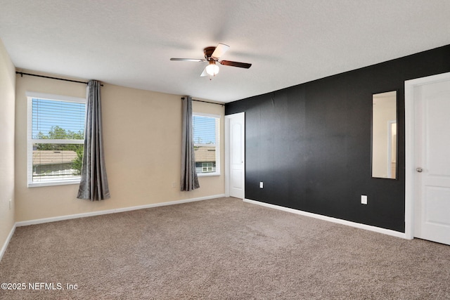 2351 Oak Stream Dr, Green Cove Springs, FL 32043 - unfurnished room featuring carpet flooring, baseboards, a ceiling fan, and a healthy amount of sunlight