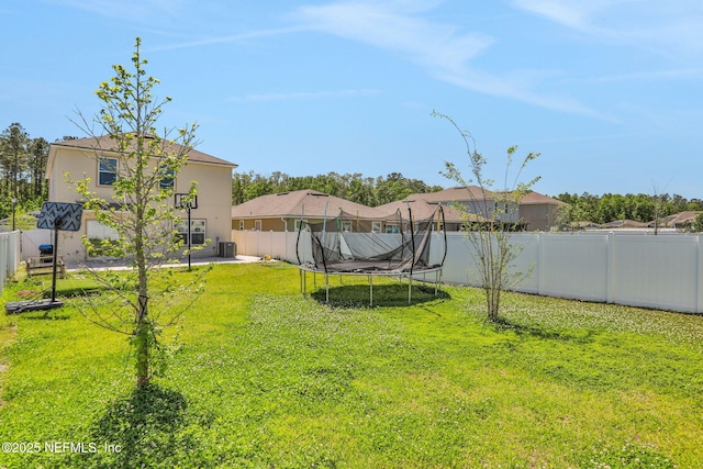 2351 Oak Stream Dr, Green Cove Springs, FL 32043 - view of yard featuring a trampoline, a fenced backyard, and a patio area