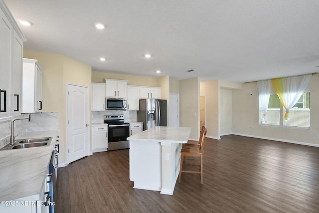 2351 Oak Stream Dr, Green Cove Springs, FL 32043 - kitchen featuring dark wood-style flooring, a center island, backsplash, appliances with stainless steel finishes, and a sink