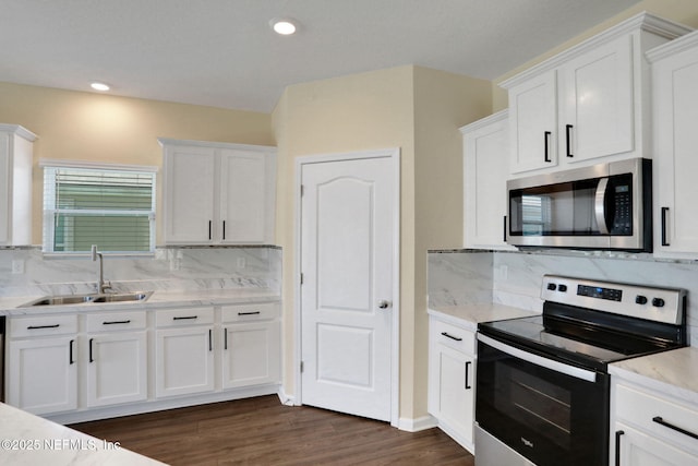 2351 Oak Stream Dr, Green Cove Springs, FL 32043 - kitchen featuring dark wood-style floors, appliances with stainless steel finishes, a sink, and white cabinetry